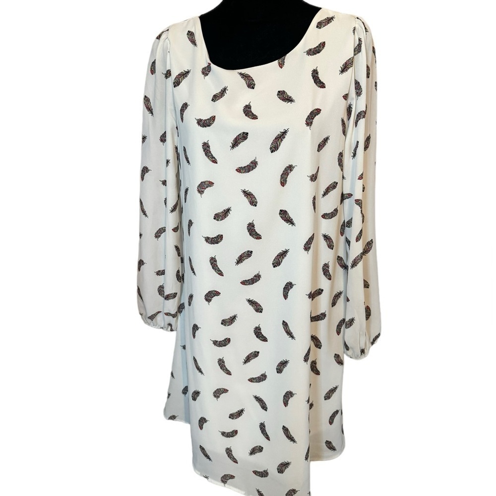 Love Kuza dress white background with red, yellow and black feathers